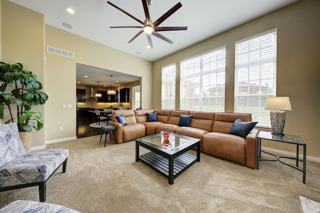 51583 Turnburry Dr, South Lyon, MI 48178 - living room with visible vents, baseboards, ceiling fan with notable chandelier, light carpet, and recessed lighting
