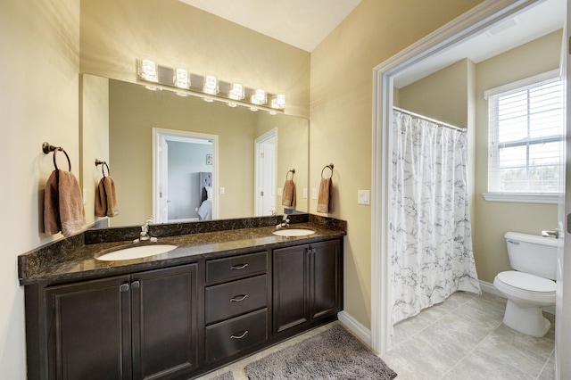 51583 Turnburry Dr, South Lyon, MI 48178 - bathroom featuring baseboards, double vanity, toilet, and a sink