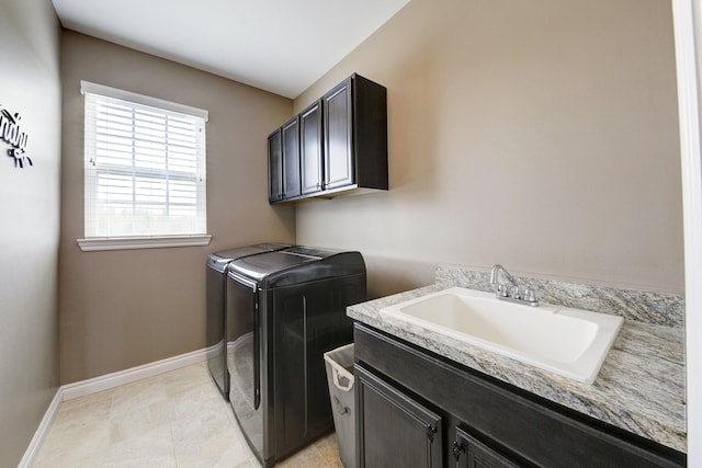 51583 Turnburry Dr, South Lyon, MI 48178 - laundry area with cabinet space, baseboards, a sink, and washer and clothes dryer