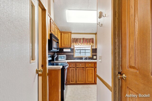 5495 N Karley Ct, Luther, MI 49656 - kitchen featuring brown cabinets, stainless steel electric range oven, tasteful backsplash, black microwave, and light countertops