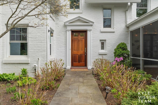 entrance to property with brick siding