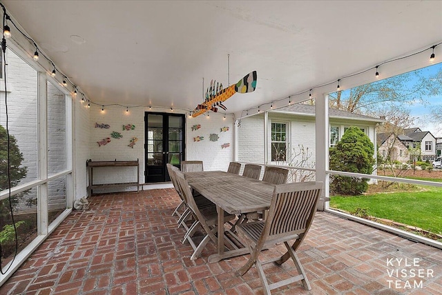 sunroom / solarium featuring french doors and rail lighting