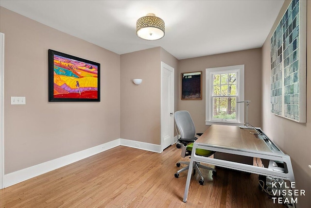 office area featuring baseboards and light wood finished floors