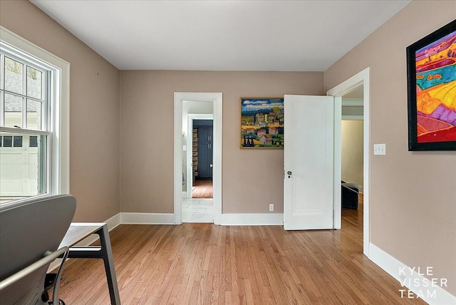 office area with light wood-type flooring and baseboards