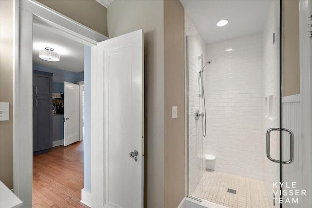 bathroom featuring a shower stall and wood finished floors