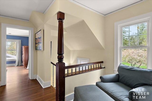 interior space featuring baseboards, ornamental molding, and wood finished floors