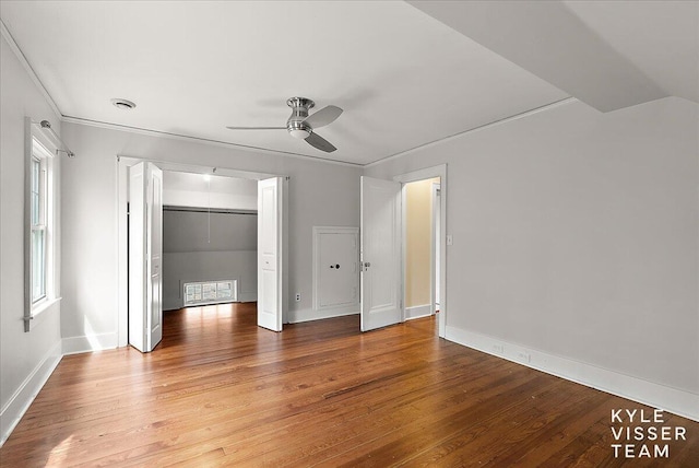 unfurnished bedroom with crown molding, baseboards, ceiling fan, and hardwood / wood-style floors