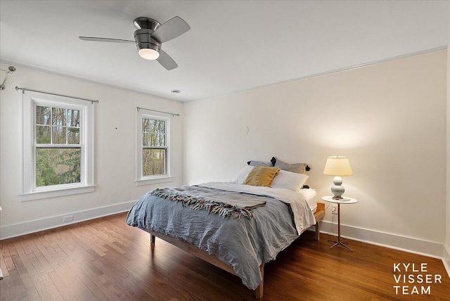 bedroom with baseboards, ceiling fan, and wood finished floors
