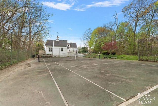 view of tennis court with fence