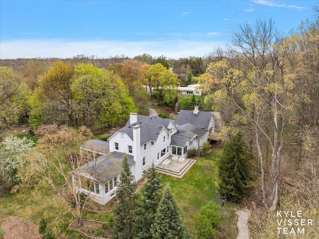 drone / aerial view with a wooded view