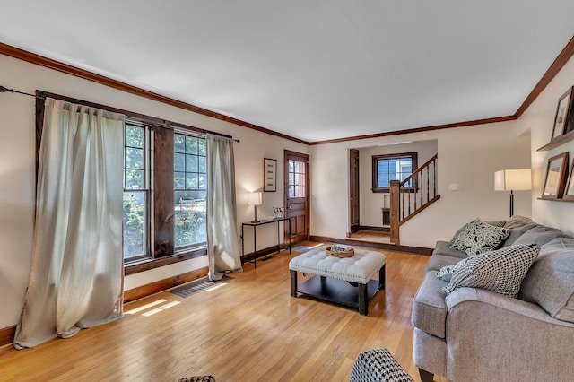 1115 Henry St, Ann Arbor, MI 48104 - living room featuring stairway, light wood-style floors, and crown molding