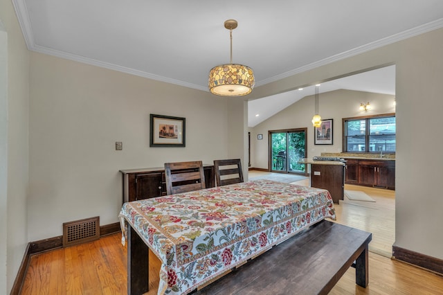 1115 Henry St, Ann Arbor, MI 48104 - dining room featuring light wood-type flooring, crown molding, and vaulted ceiling
