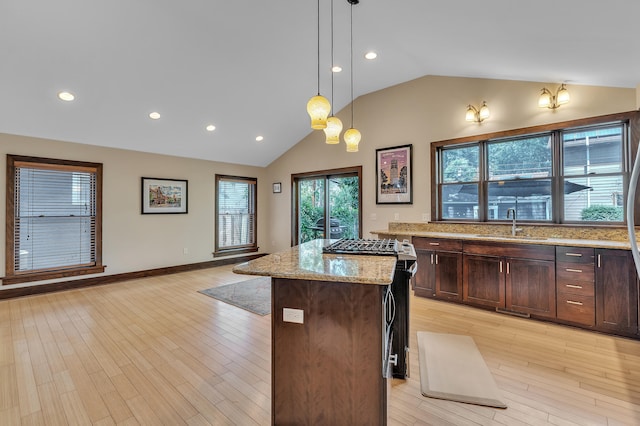 1115 Henry St, Ann Arbor, MI 48104 - kitchen featuring lofted ceiling, light stone countertops, recessed lighting, light wood finished floors, and pendant lighting
