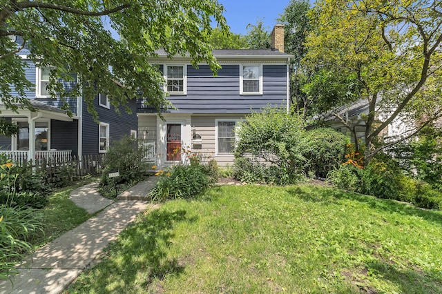 1115 Henry St, Ann Arbor, MI 48104 - view of front of property featuring a chimney and a front yard