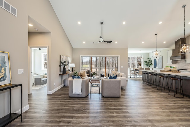 5215 Grande View Ln, Jackson, MI 49201 - living room with a notable chandelier, high vaulted ceiling, dark wood finished floors, recessed lighting, and visible vents