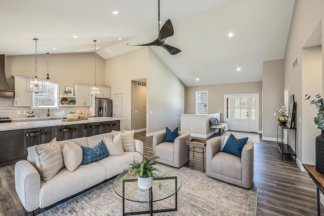 5215 Grande View Ln, Jackson, MI 49201 - living area featuring visible vents, baseboards, dark wood-type flooring, and high vaulted ceiling