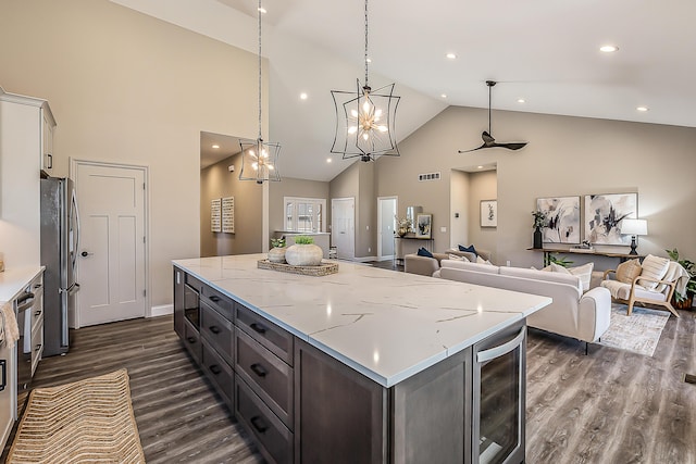 5215 Grande View Ln, Jackson, MI 49201 - kitchen with a center island, stainless steel fridge with ice dispenser, open floor plan, wine cooler, and dark wood-type flooring