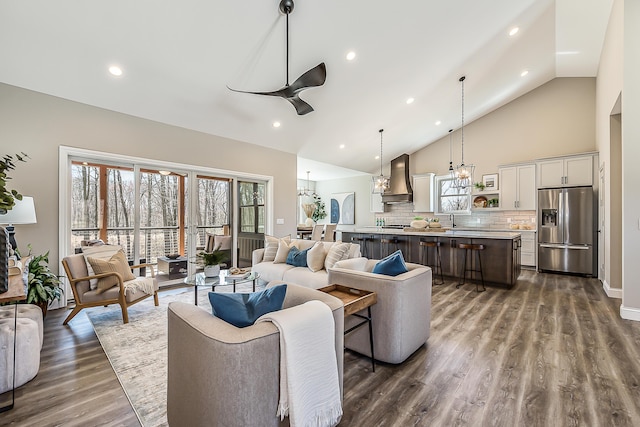 5215 Grande View Ln, Jackson, MI 49201 - living room featuring recessed lighting, dark wood finished floors, ceiling fan with notable chandelier, and high vaulted ceiling