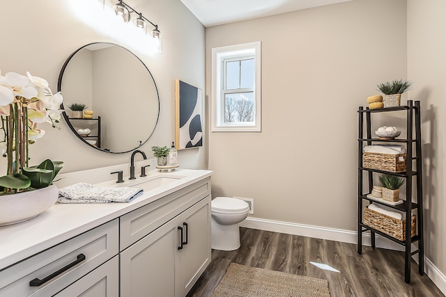 5215 Grande View Ln, Jackson, MI 49201 - bathroom featuring vanity, baseboards, wood finished floors, and toilet