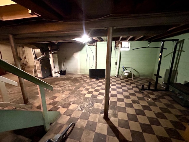 basement with tile patterned floors and heating unit