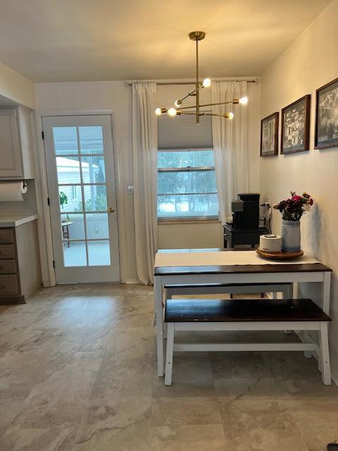 dining room with a chandelier and concrete floors
