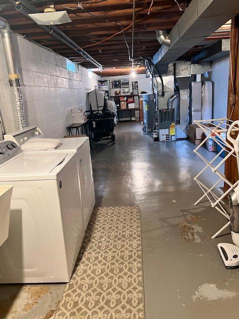 unfinished below grade area with separate washer and dryer, heating unit, and concrete block wall