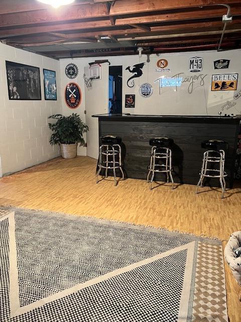 bar with a bar and wood finished floors