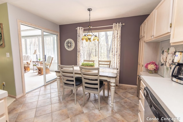 dining space featuring baseboards and a chandelier