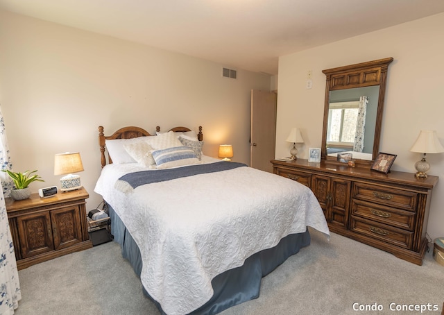 bedroom featuring visible vents and light carpet