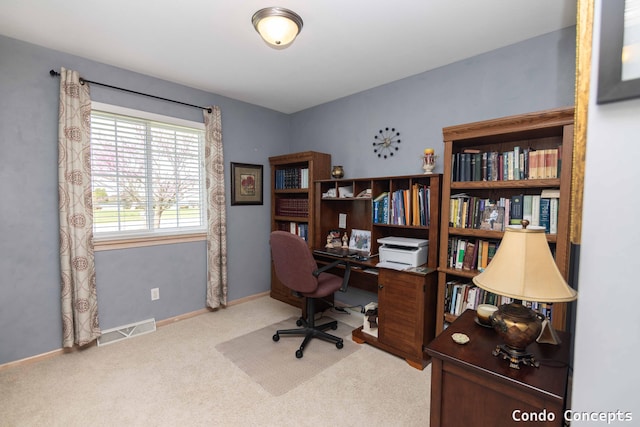 carpeted office space with baseboards and visible vents