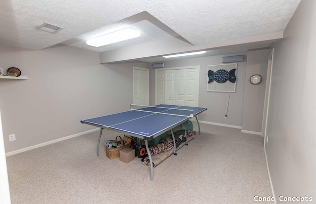playroom with carpet floors, baseboards, and a textured ceiling