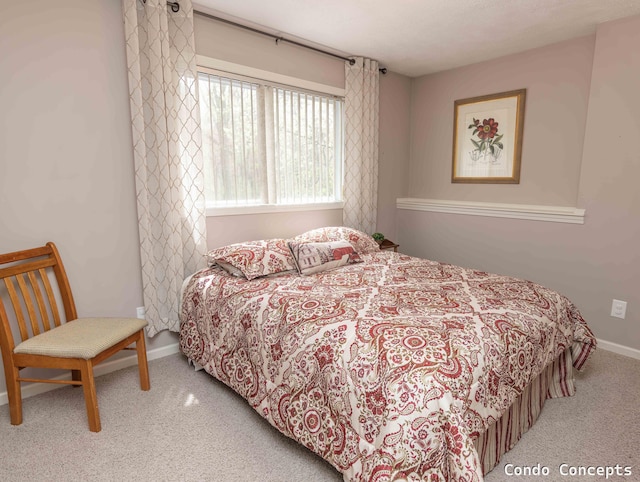 carpeted bedroom featuring baseboards