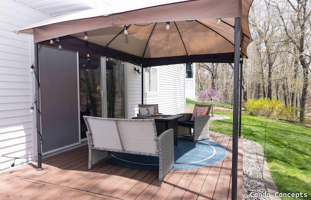 deck with outdoor dining area, a gazebo, and a yard