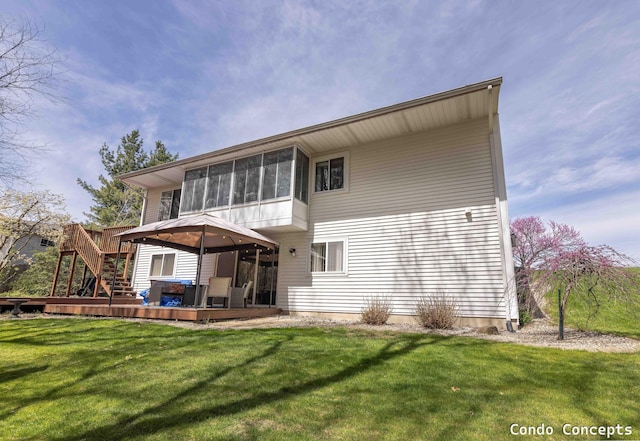 rear view of property with stairs, a gazebo, a wooden deck, a sunroom, and a yard