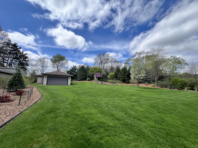 3817 Butterworth St SW, Grand Rapids, MI 49534 - view of grassy yard featuring an outdoor structure and a detached garage