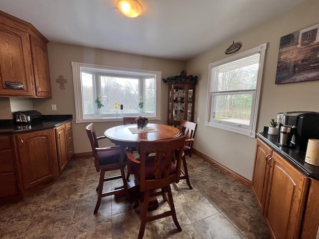 3817 Butterworth St SW, Grand Rapids, MI 49534 - dining area featuring baseboards and stone finish floors