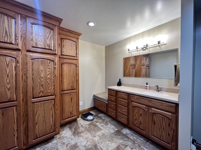 3817 Butterworth St SW, Grand Rapids, MI 49534 - bathroom featuring vanity, baseboards, and recessed lighting