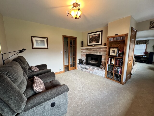 3817 Butterworth St SW, Grand Rapids, MI 49534 - carpeted living area with a stone fireplace and baseboards