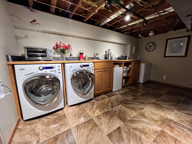 3817 Butterworth St SW, Grand Rapids, MI 49534 - laundry room featuring independent washer and dryer, cabinet space, and baseboards