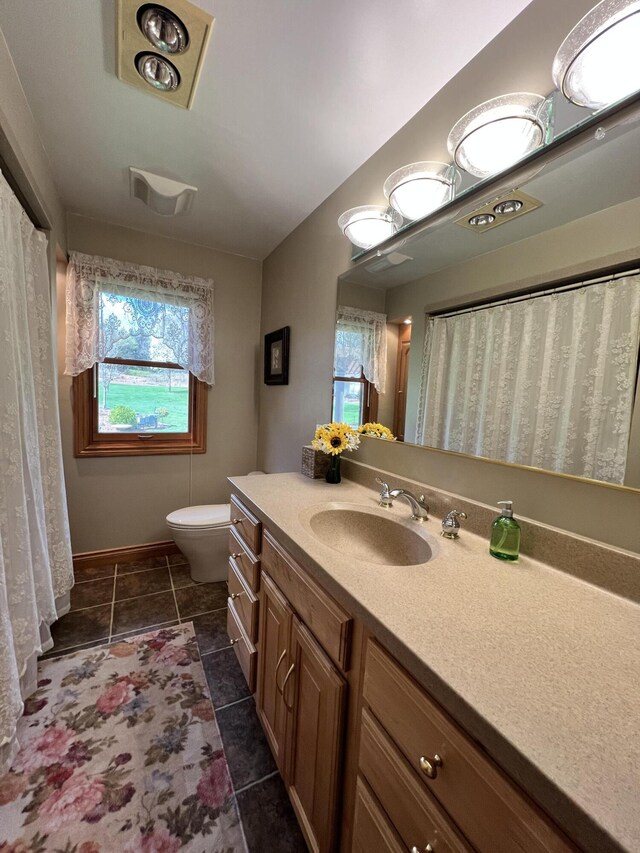 3817 Butterworth St SW, Grand Rapids, MI 49534 - bathroom featuring vanity, toilet, and tile patterned floors