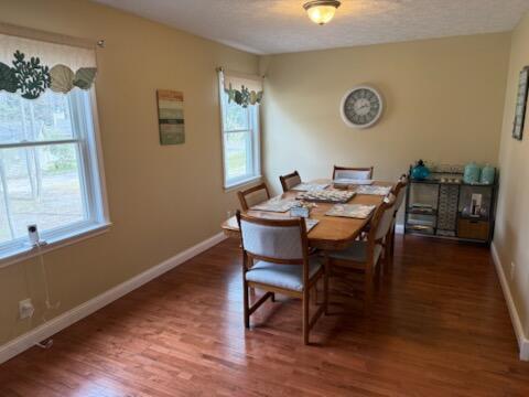 935 E 6th St, Pentwater, MI 49449 - dining room featuring baseboards and wood finished floors