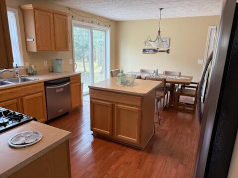 935 E 6th St, Pentwater, MI 49449 - kitchen featuring dark wood-style flooring, a sink, light countertops, a textured ceiling, and stainless steel appliances