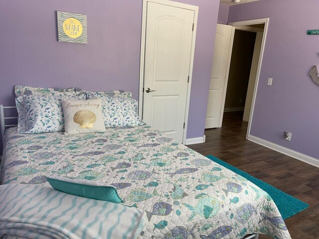 935 E 6th St, Pentwater, MI 49449 - bedroom with baseboards and dark wood finished floors