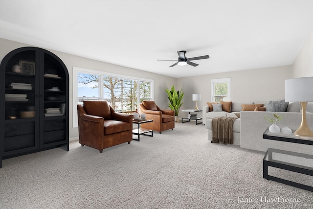carpeted living room with ceiling fan