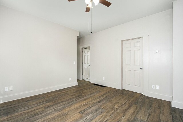 311 Robey Pl SE, Grand Rapids, MI 49506 - empty room with visible vents, a ceiling fan, dark wood-style floors, and baseboards