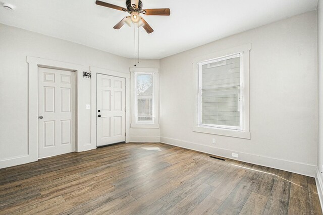 311 Robey Pl SE, Grand Rapids, MI 49506 - unfurnished bedroom with a ceiling fan, visible vents, wood finished floors, and baseboards
