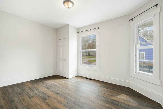 311 Robey Pl SE, Grand Rapids, MI 49506 - unfurnished room featuring dark wood-style floors, visible vents, and baseboards