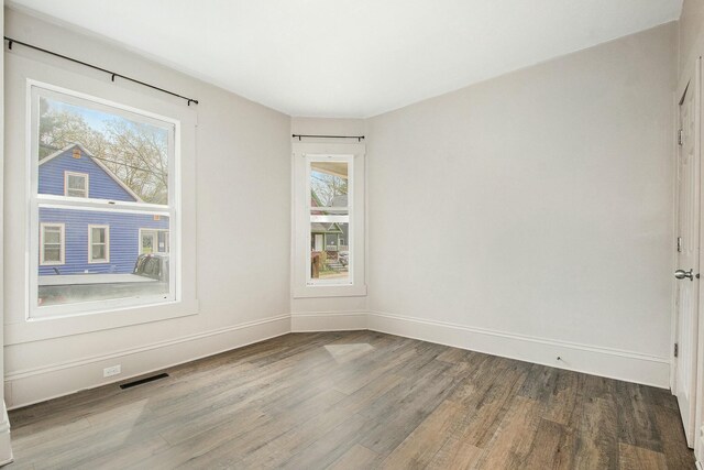 311 Robey Pl SE, Grand Rapids, MI 49506 - unfurnished room with visible vents, wood finished floors, and baseboards