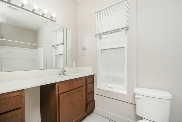 311 Robey Pl SE, Grand Rapids, MI 49506 - bathroom with toilet, walk in shower, vanity, and tile patterned flooring