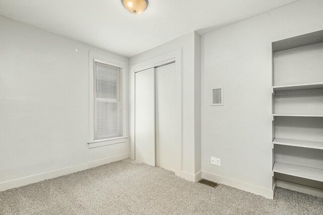311 Robey Pl SE, Grand Rapids, MI 49506 - unfurnished bedroom featuring baseboards, visible vents, a closet, and carpet flooring